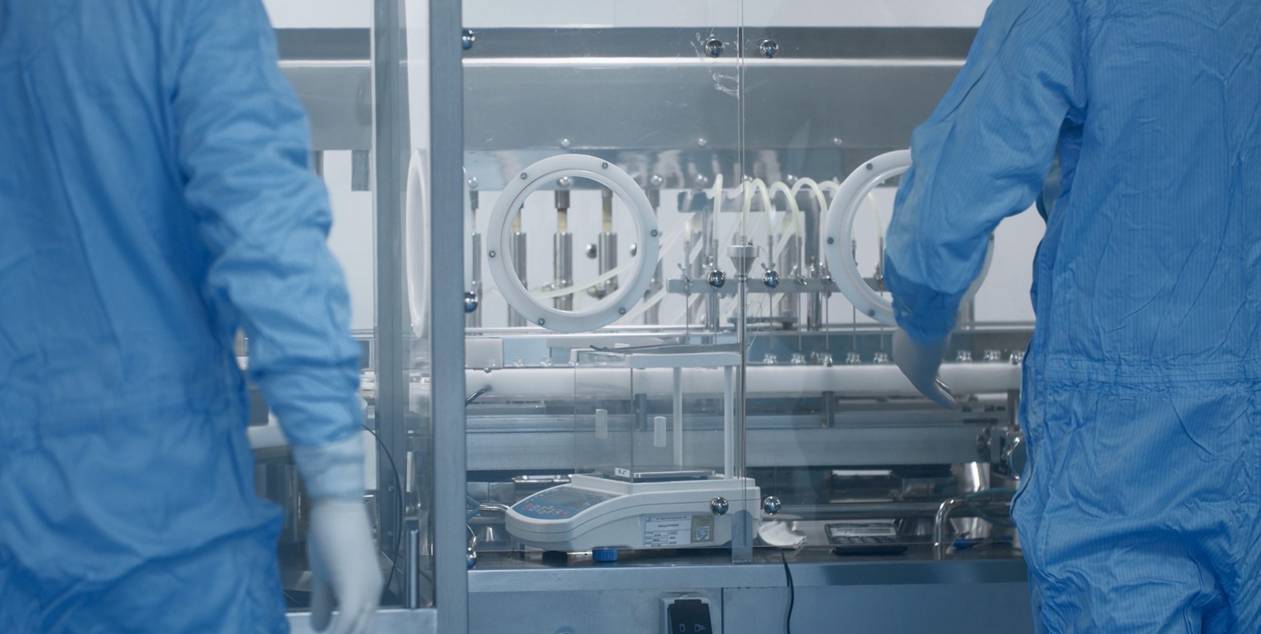 Image of a pharmaceutical training session showcasing a blend of practical application and digital learning for improved efficiency and GMP compliance